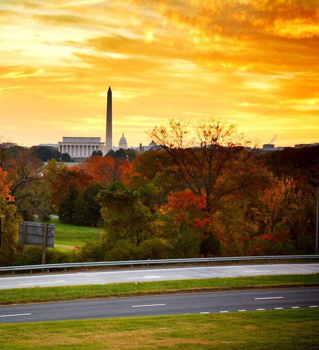 Golden skies at sunrise in Arlington, with the Washington Monument in the background.